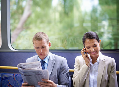 Buy stock photo Bus, business people and commute for communication or news, reading newspaper and phone call for info. Woman, networking and app for conversation or travel, newsletter and man for article on transit