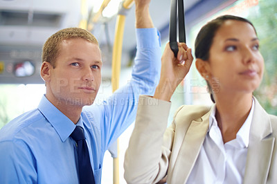 Buy stock photo Business people, man and woman in bus or public transport  for travel and commute outdoors against blurred background. Diverse colleagues and working partners  standing and thinking on trip 
