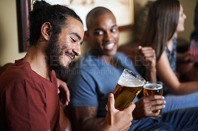 Buy stock photo Shot of friends drinking and having fun in a pub