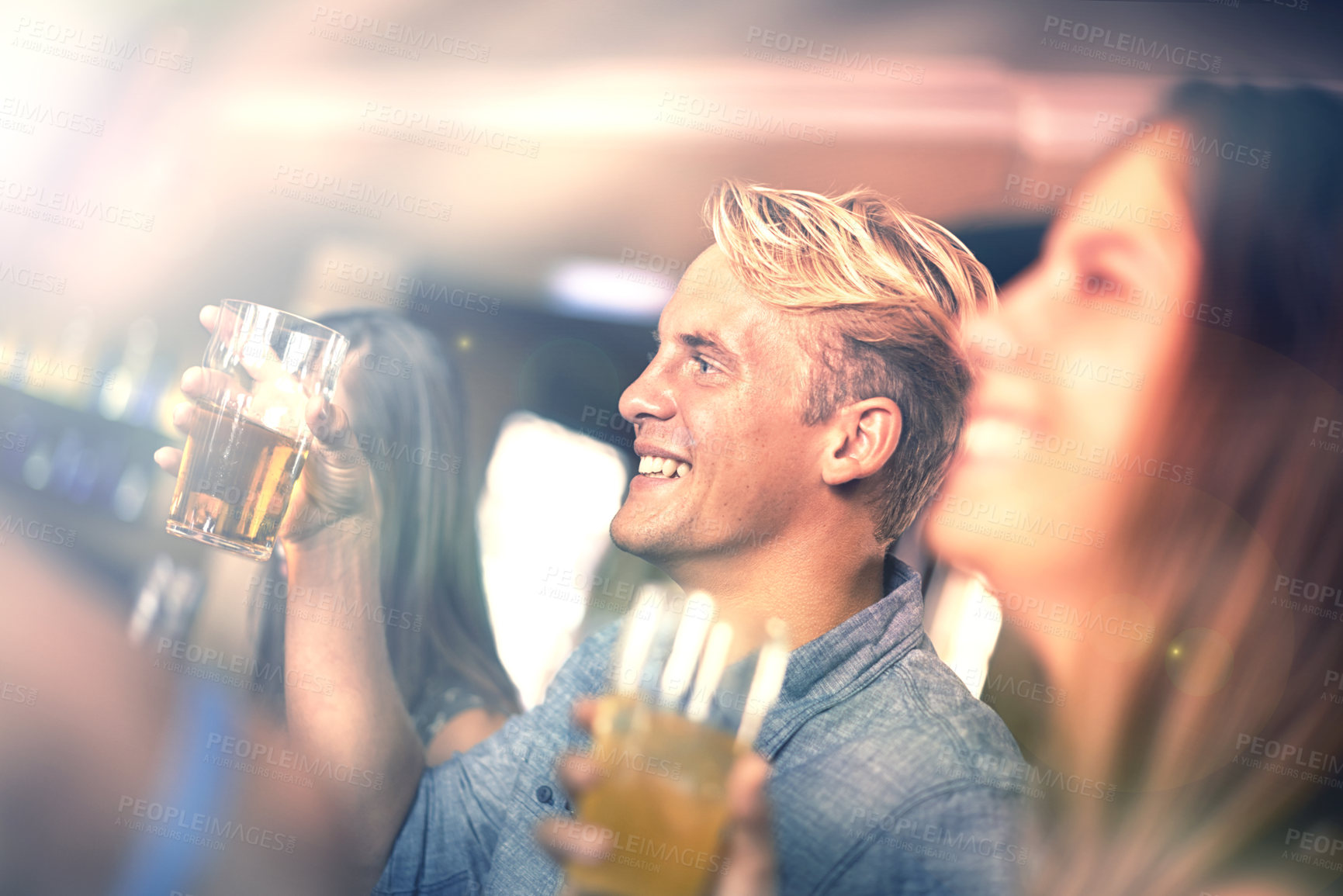 Buy stock photo Smile, man and drinking beer with friends in pub at party for celebration together in restaurant to relax for leisure in club. Happy, group or people with alcohol in glass at bar for social gathering