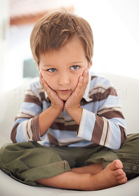 Buy stock photo A little boy sitting sadly after being reprimanded