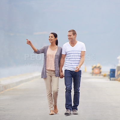 Buy stock photo Couple, ocean and happy in boardwalk on vacation for honeymoon, love and relax in New Zealand. Pointing, relationship and beach for travel on holiday with trip for support, bonding and holding hands 