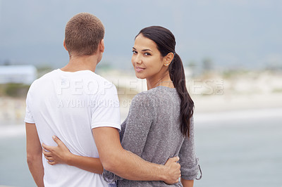 Buy stock photo Couple, beach and hug for bonding on vacation with honeymoon, love and relax in New Zealand. Back view, relationship and ocean for travel on holiday with smile for date, together and support.