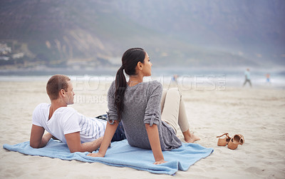 Buy stock photo Couple, beach and vacation on blanket, picnic or relaxing on seashore getaway. Romantic, honeymoon and love between happy husband and wife, married and date on ocean coast enjoying peaceful sunshine