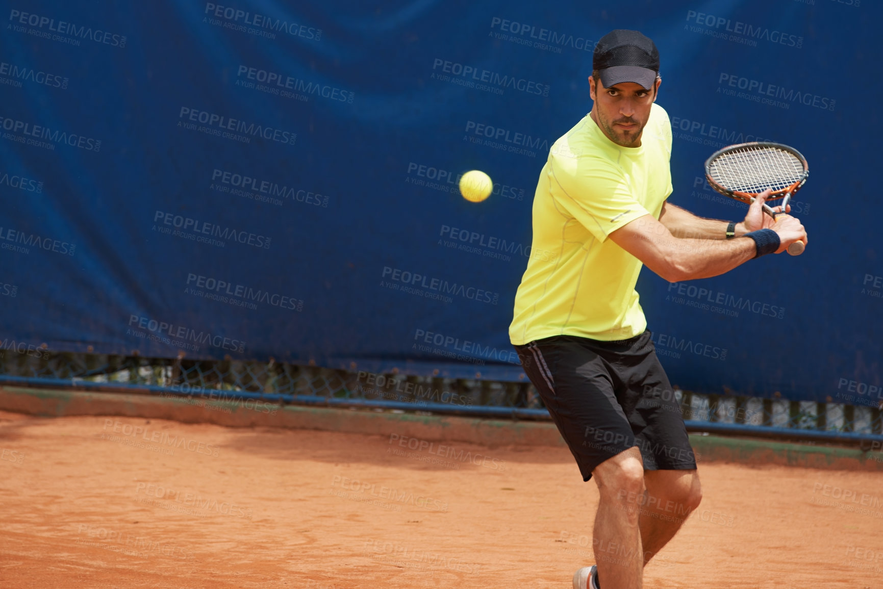 Buy stock photo A male tennis player on a clay court