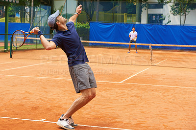 Buy stock photo Exercise, sports and tennis with man serving on clay court to start competition or game from back. Fitness, training or workout and athlete man with racket in stadium or venue at beginning of match
