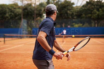 Buy stock photo Tennis, training and man in game of sport, competition or exercise for fitness on court. Athlete, workout and play on pitch outdoor in summer with action, challenge and person in contest from back