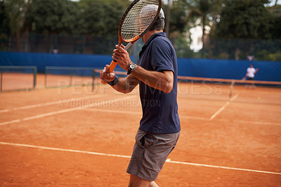 Buy stock photo Tennis, game and man training for sport, competition or exercise for fitness on court. Athlete, workout and play on pitch outdoor in summer with action, challenge and person in contest from back