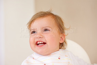 Buy stock photo Baby, smile and laughing for fun, play and watch of game and joke as sitting in high chair in home. Happy, young or child for joy, positive or humor for healthy growth or early childhood development