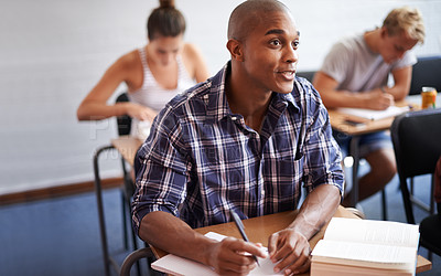 Buy stock photo Black man, student and writing with book in classroom for studying, reading or summary at university. African male person or young academic writer with notebook for assignment, test or exam at campus