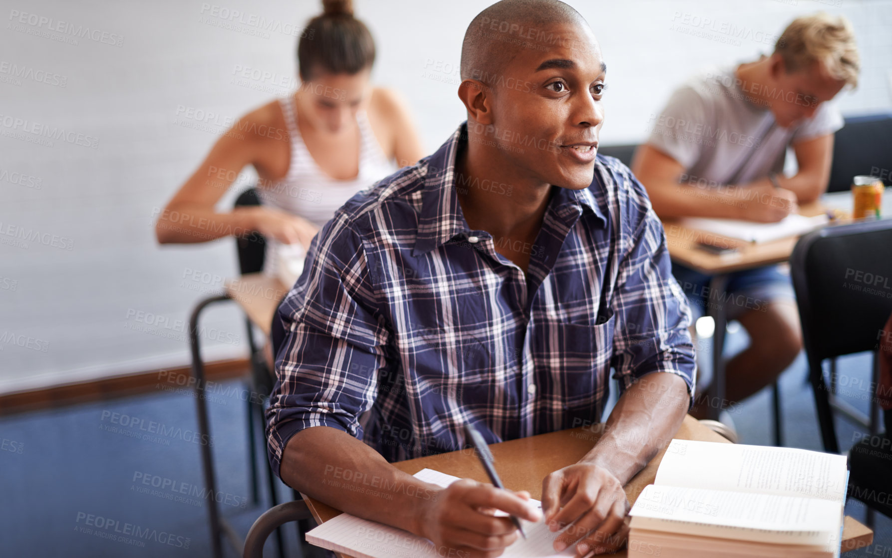 Buy stock photo Black man, student and writing with book in classroom for studying, reading or summary at university. African male person or young academic writer with notebook for assignment, test or exam at campus