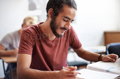 Buy stock photo Man, reading and classroom with book for thinking, test or solution at university with education. Person, learning and assessment with writing, pen and happy with studying for development at college