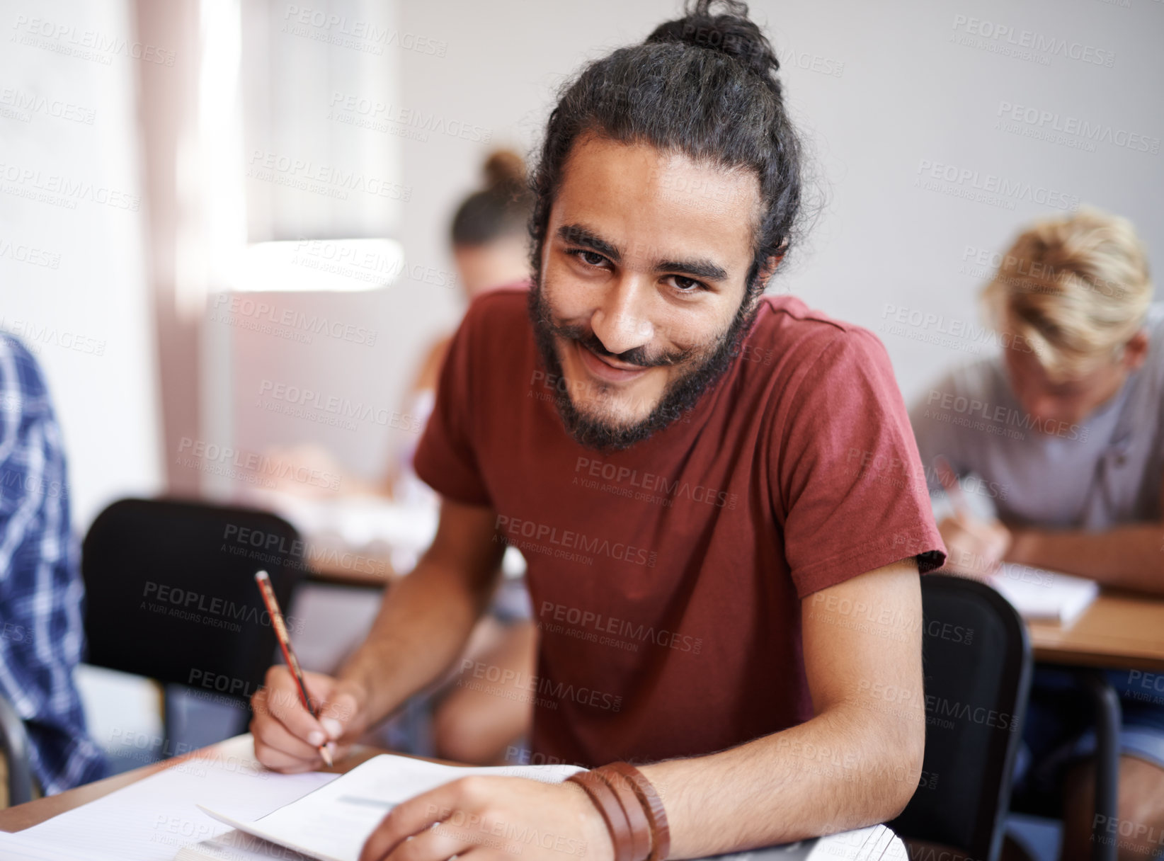 Buy stock photo Portrait, university and students in a class, writing and knowledge with books and exam. Face, person and man on campus with learning and studying with support and happy guy with notes and college