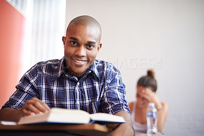 Buy stock photo Classroom, university student and black man with smile, portrait and reading textbook for studying. Male person, happy and learning for information with research for education with scholarship