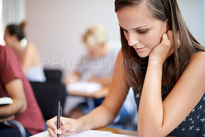 Buy stock photo University, student and woman writing on notebook in academy for education with scholarship. Female person, exam and classroom for learning, knowledge and information from research for girl on desk