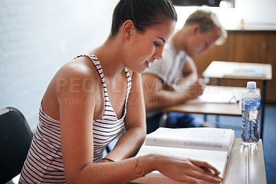 Buy stock photo College student, reading and desk in classroom with textbook for english literature or language for exam. Female person, university and scholarship for learning or education, knowledge and studying.