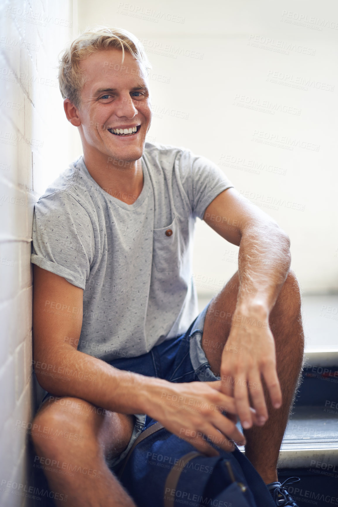 Buy stock photo Portrait, stairs and university with student, man and smile with lunch break and education. Face, person and guy sitting on stairwell, relaxing and college with knowledge and happy with scholarship