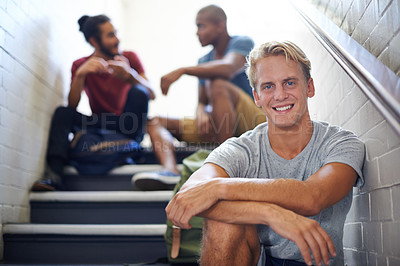 Buy stock photo Portrait, student and man with friends on stairs of college with backpacks, hangout and happiness. Steps, male person and relax with smile in university with people, gen z and scholarship for guy