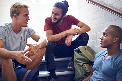 Buy stock photo Happy man, student and friends talking on stairs with group for conversation, social interaction or chat at campus. University people or male person with smile on staircase for discussion at college