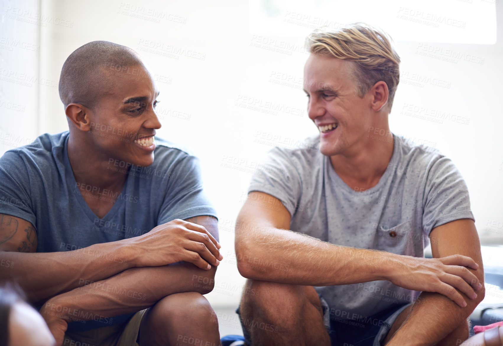 Buy stock photo Male student, diversity and laugh on campus stairs, education and smile before lecture. College, funny and joke in conversation between friends, teamwork and partners for project and study for exam