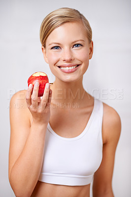 Buy stock photo Portrait, woman and smile in studio with apple, nutrition and diet for health and wellness. Female person, fruit and workout for fitness or weight loss, wellbeing and happiness on white background