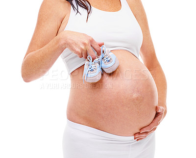 Buy stock photo Woman, pregnant and studio with belly, baby shoes and maternity with confidence. Mother, proud and confident with care, child and stomach for positive parenting and motherhood on white background