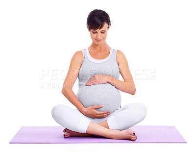 Buy stock photo A young expectant mother meditating peacefully while isolated on white