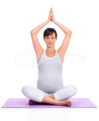 Buy stock photo A young expectant mother meditating peacefully while isolated on white