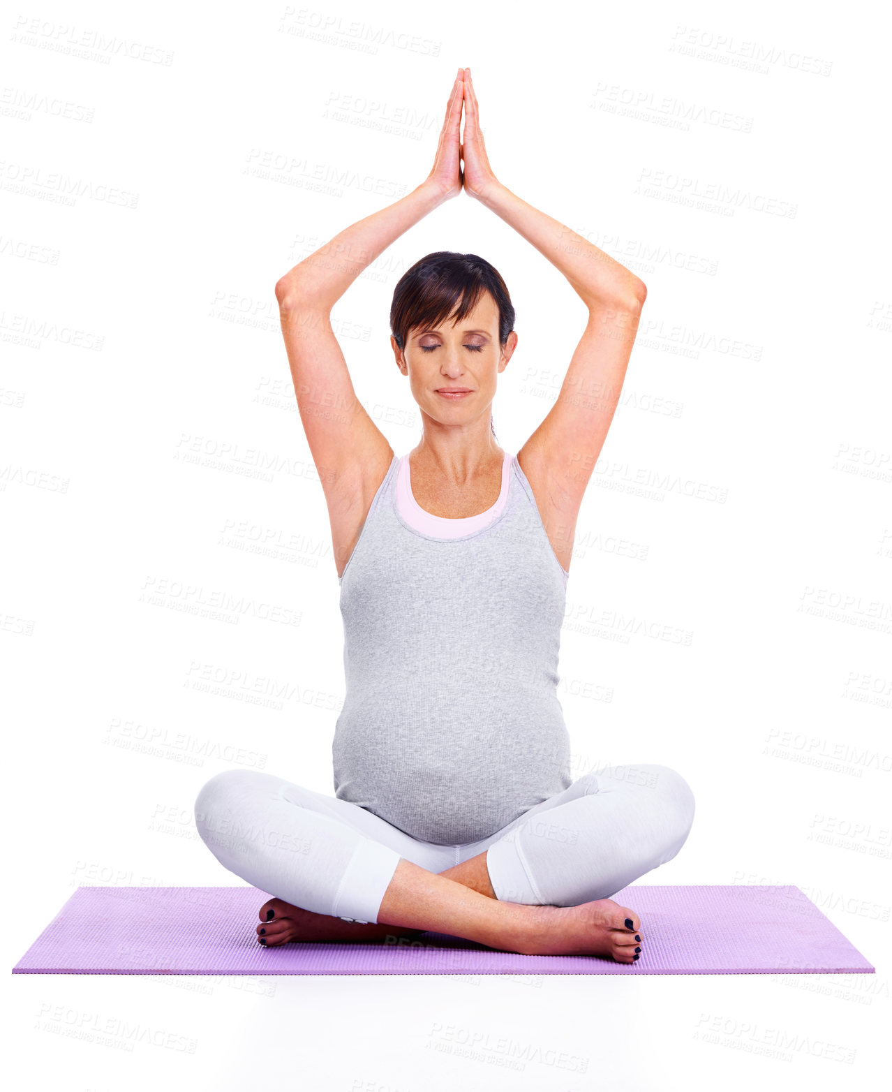 Buy stock photo A young expectant mother meditating peacefully while isolated on white