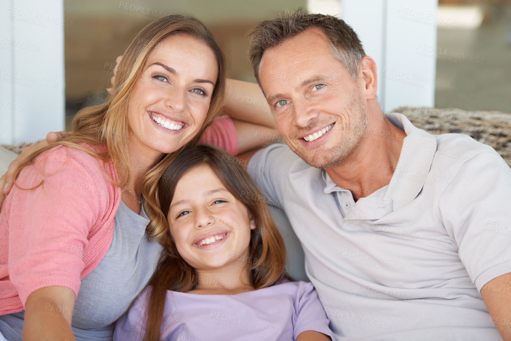 Buy stock photo A cropped shot of a beautiful family relaxing comfortably at home