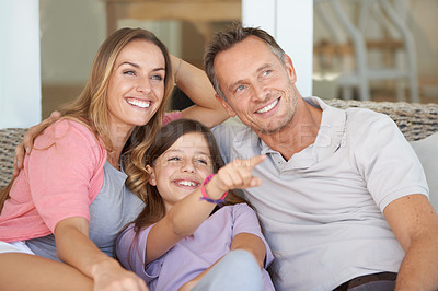 Buy stock photo Mom, dad and child with view on patio together with point to relax on sofa with smile, bonding or care on holiday. Father, mother and daughter for sign with idea, show or direction at family home