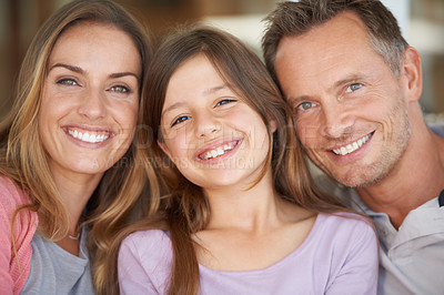 Buy stock photo Portrait of a small family smiling happily while spending time together