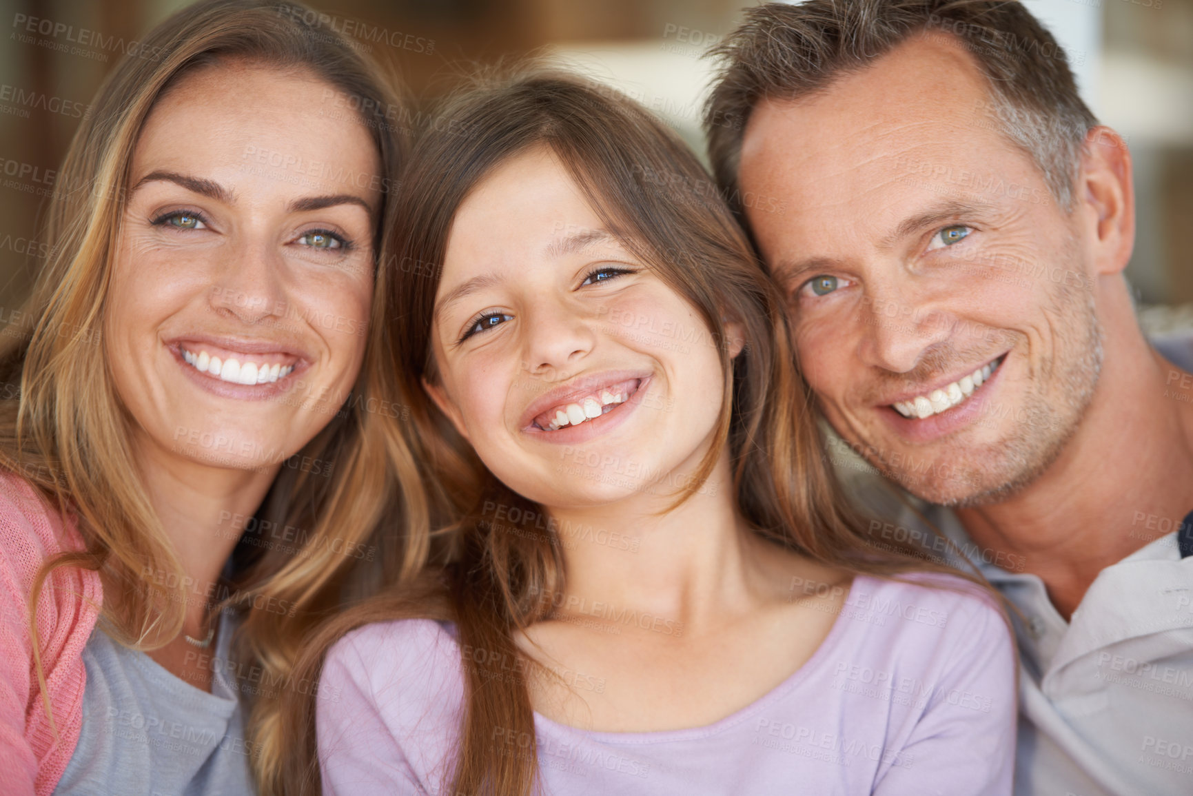 Buy stock photo Portrait of a small family smiling happily while spending time together