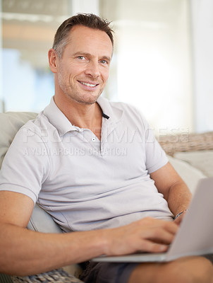 Buy stock photo Man, laptop and portrait on patio in home, chair and typing with search for movies on website. Person, computer and relax on couch, scroll and happy for streaming subscription on holiday at apartment