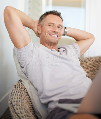 Buy stock photo A mature man leaning back on a chair with his hands behind his head