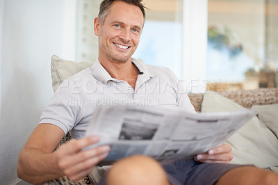 Buy stock photo Man, newspaper and happy in portrait on sofa to relax with reading, knowledge and information in home. Person, newsletter or publication for update on current affairs with sports, finance and news