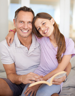 Buy stock photo Father, girl and book on sofa for portrait with hug, care and connection in family home with reading. Dad, child and happy together on couch with teaching, education and embrace for bonding in house