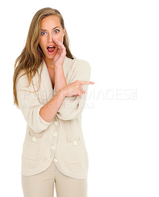 Buy stock photo Shot of a young woman telling you a secret while pointing away