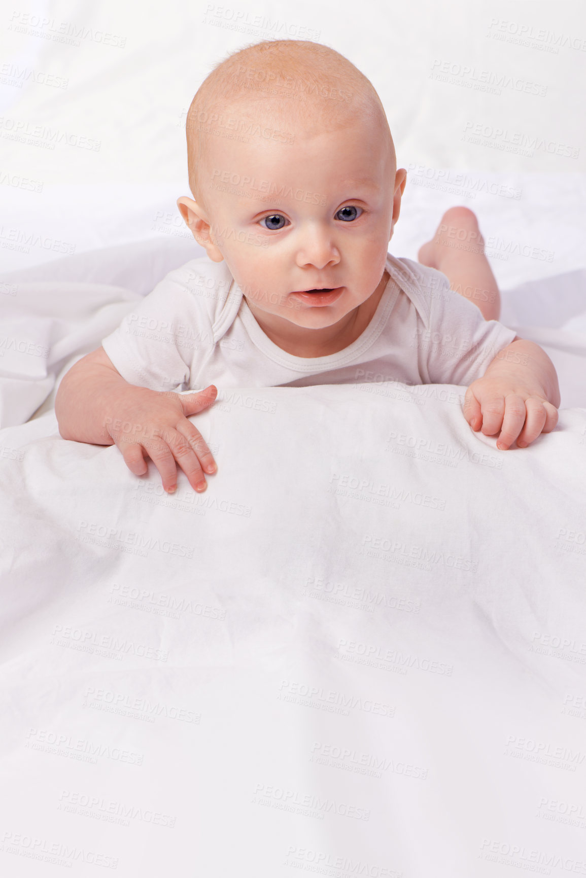 Buy stock photo Bed, blanket and face of baby in studio on a white background for child development, care and growth. Sleep, leisure and isolated newborn rest, relax and nap for childhood, wellness and comfort 