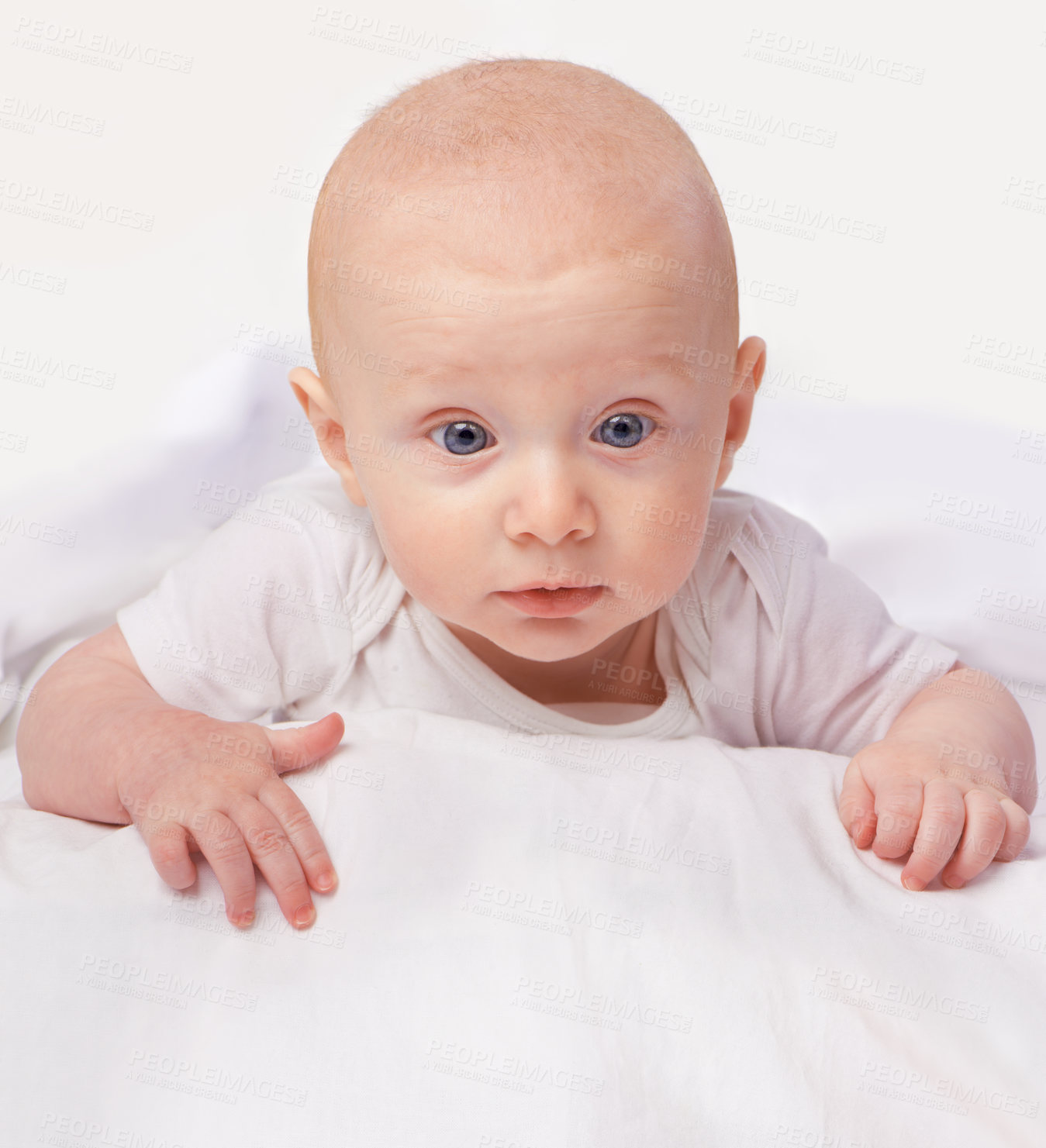 Buy stock photo Baby, blue eyes and shock with laying on bed for curiosity, surprise and reaction in bedroom at house. Adorable, child and cute infant with vest in home to observe, relax wonder for knowledge