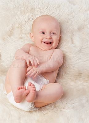 Buy stock photo Baby, cute and laugh in bedroom, blanket and playtime in diaper for child development in happiness. Infant, kid and wellness for newborn, adorable and rug in house for home and toddler fun