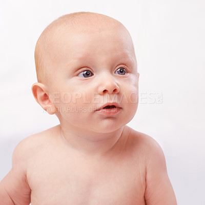 Buy stock photo Young, cute and face of baby on a white background for child development, youth and growth. Curious, facial expression and closeup of isolated newborn for childhood, wellness and adorable in studio