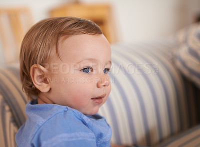 Buy stock photo Baby boy, smile and face profile in sofa relaxing, resting and sitting in living room. Adorable child, growth and development at home kid or infant, happiness and casual outfit or clothes in house