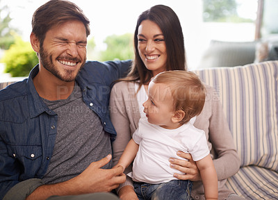 Buy stock photo Happy family, smile and relax in sofa mother, father and child at home together. Married couple, parents and playing with baby boy for laughing, bonding and embrace relationship in living room