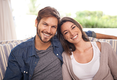 Buy stock photo Portrait of a young married couple relaxing at home