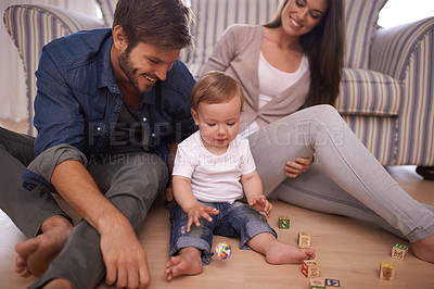Buy stock photo Parents, toddler and building blocks on floor, love and growth or development toys for learning in living room. Happy family, kid or interactive game for child or bonding together with care in home