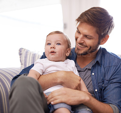 Buy stock photo Father, smile or baby in home for playing, happiness and bonding in a family house in living room. Relax, boy and toddler on sofa with dad, love or care for child development, wellness or growth 