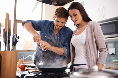 Buy stock photo Happy couple, pan and cooking together in the kitchen with food or healthy ingredients for dinner at home. Man and woman smiling in happiness for meal preparation, lunch or frying vegetables on stove