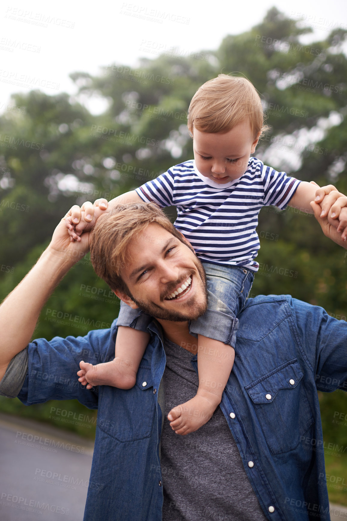 Buy stock photo Portrait, smile or father with toddler in outdoor, love or bonding together for child growth or development. Happy family, dad or kid on shoulders to play, face or responsibility for son on weekend
