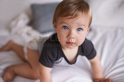 Buy stock photo Curious, baby and crawl on bed in portrait, boy and kid for motor skills in bedroom on weekend. Child development, toddler and calm or comfortable, wellness and learn for health and growth in home
